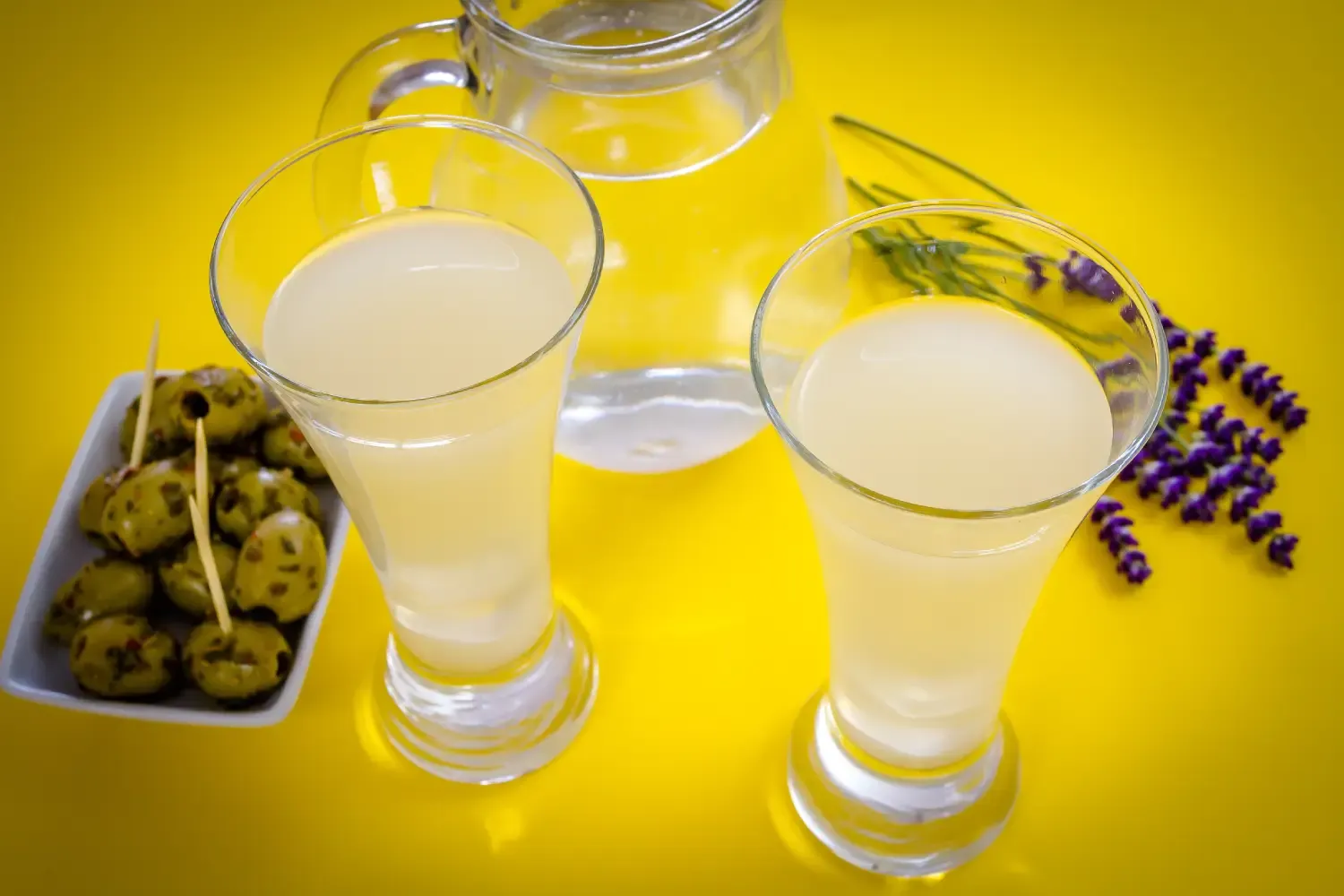 A glass of French Pastis liqueur turning cloudy after adding water