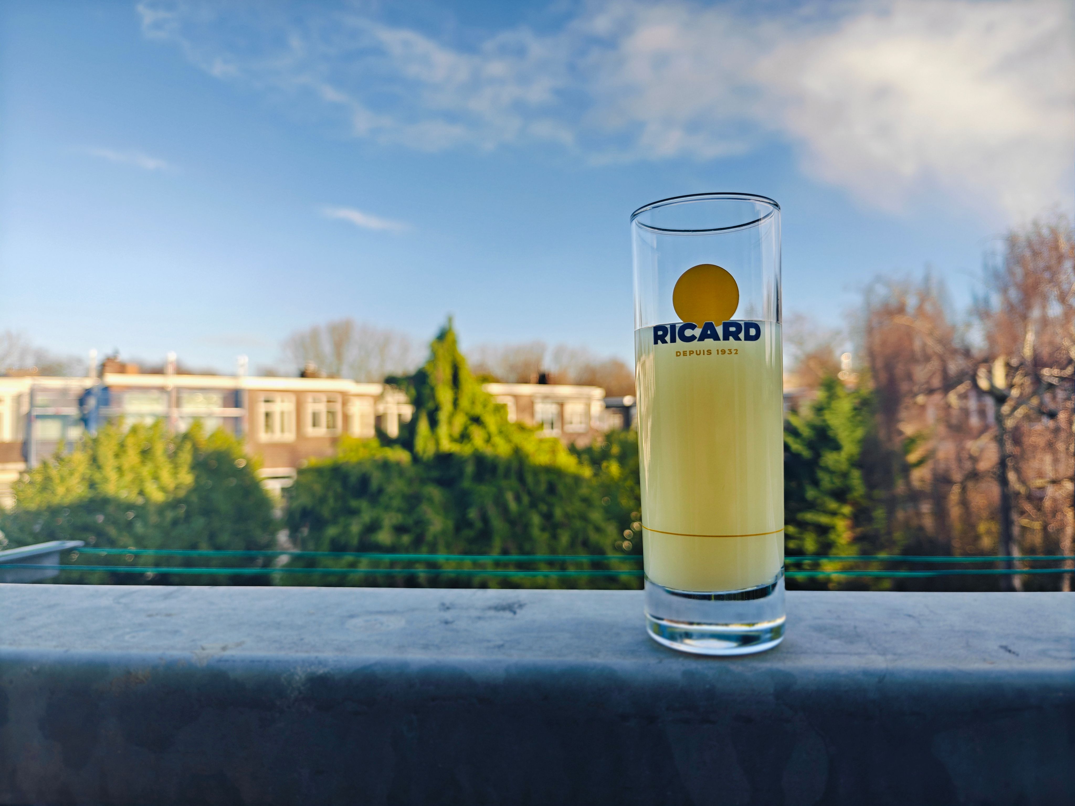 A glass of Ricard on a balcony